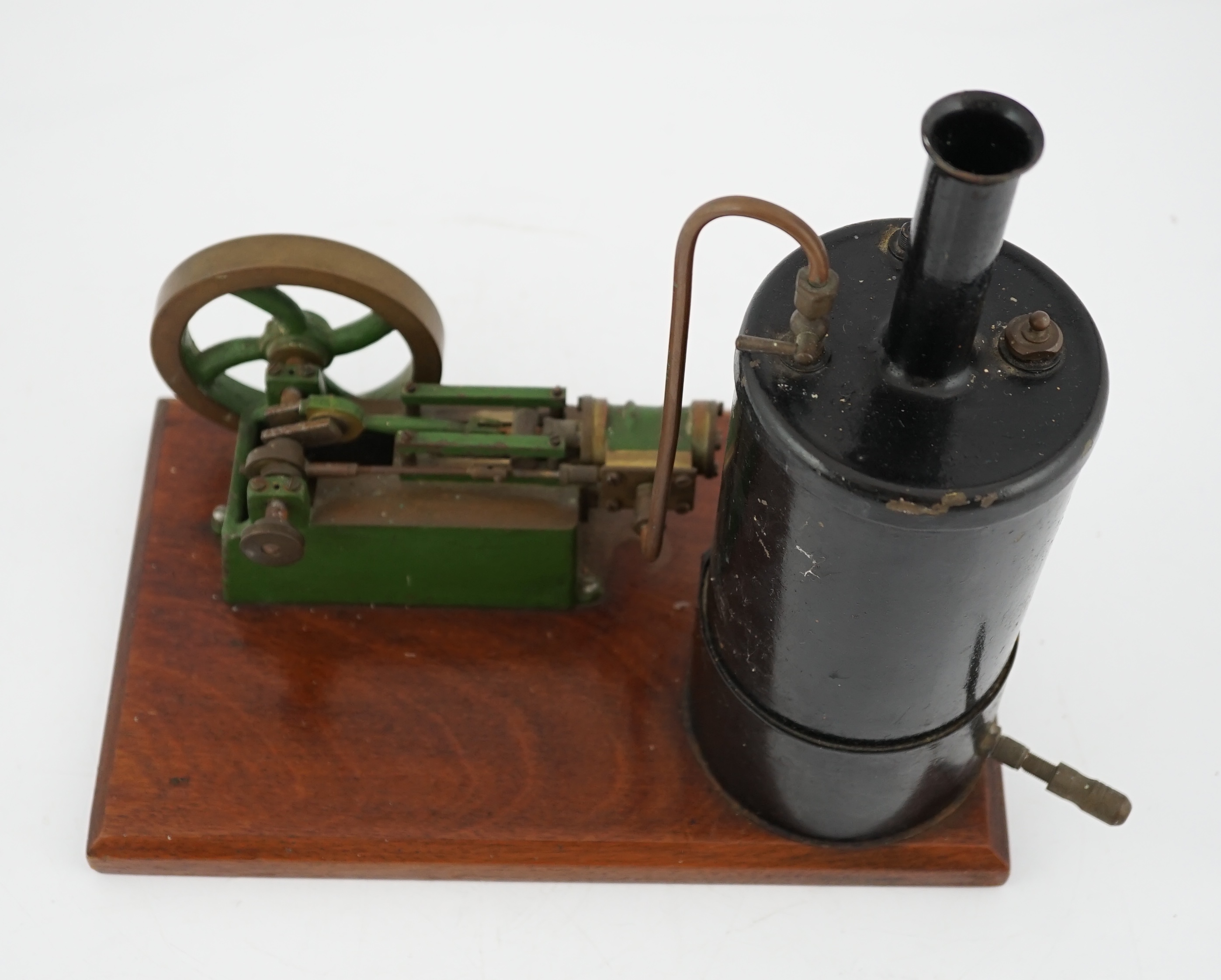 A Stuart Turner style stationary steam plant, with vertical boiler with fittings for a water sight glass and a pressure gauge (both missing), connected to a single cylinder horizontal steam engine with slide valve, mount